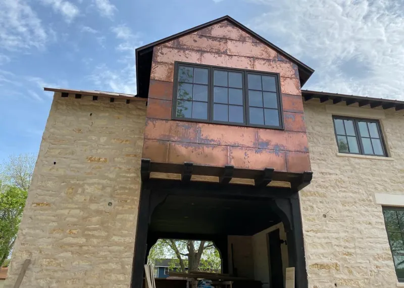 Copper metal panel facade on a stone building for Metal Roof Coating in Bastrop