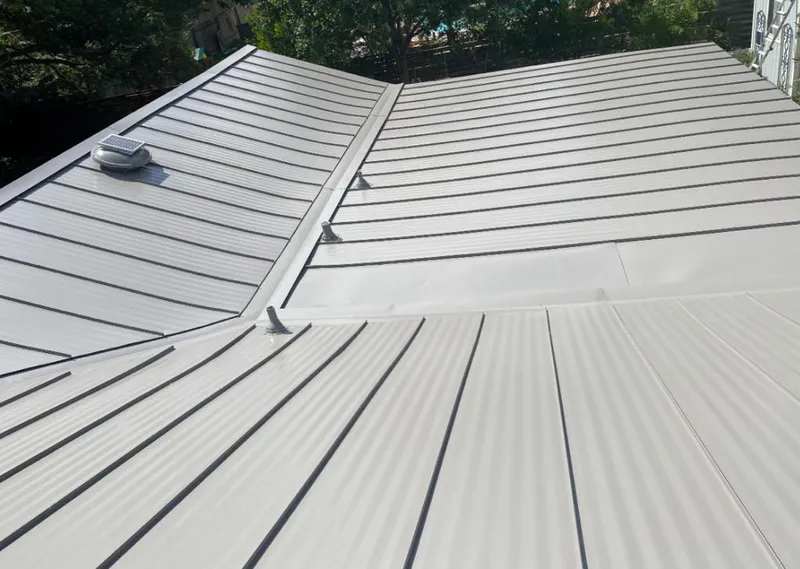 Solar attic fan installed on a metal roof for Roof Ventilation in Bastrop